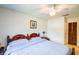 Bedroom with a decorative headboard, ceiling fan, and light blue comforter at 2729 Hilda Ct, Orlando, FL 32826
