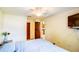 Bright bedroom with ceiling fan, closet, and a glimpse into the kitchen at 2729 Hilda Ct, Orlando, FL 32826