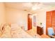 This bedroom has a ceiling fan, wood floors, louvred closet doors, and a white metal daybed at 2729 Hilda Ct, Orlando, FL 32826
