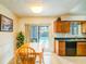 Cozy dining area with view of the pool and a small, functional kitchen at 2729 Hilda Ct, Orlando, FL 32826