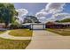 Charming single-story home featuring a two-car garage, blue trim, and well-maintained landscaping at 2729 Hilda Ct, Orlando, FL 32826