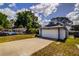 Charming single-story home featuring a two-car garage, blue trim, and well-maintained landscaping at 2729 Hilda Ct, Orlando, FL 32826