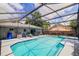 This screened-in pool offers a spa and outdoor dining for luxurious outdoor living at 2729 Hilda Ct, Orlando, FL 32826