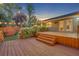 Backyard with string lights and a wooden deck with access to the home at 275 W 4Th St, Chuluota, FL 32766