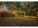 Backyard with wooden steps leading to a lawn and string lights strung between the trees at 275 W 4Th St, Chuluota, FL 32766