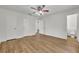 Bright bedroom with light wood floors, ceiling fan, and ensuite bathroom access at 275 W 4Th St, Chuluota, FL 32766