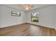 Bright bedroom featuring wood-style flooring and two windows for natural light at 275 W 4Th St, Chuluota, FL 32766