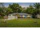 Lovely single-story home featuring mature palm trees, green grass, and serene landscaping at 275 W 4Th St, Chuluota, FL 32766