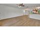 Large living room with wood flooring and access to the kitchen at 275 W 4Th St, Chuluota, FL 32766
