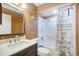 Updated bathroom with a vanity, toilet, and tiled shower/tub combo with decorative curtain at 2990 Mallard Dr, Deltona, FL 32738