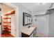 Bright bathroom with white vanity and a unique closet with custom shelving at 2990 Mallard Dr, Deltona, FL 32738