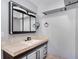 Bathroom with white vanity, hooks, and neutral-toned tile flooring at 2990 Mallard Dr, Deltona, FL 32738