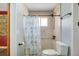 Bathroom with blue-and-white printed shower curtain and modern bronze fixtures at 2990 Mallard Dr, Deltona, FL 32738