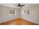 Cozy bedroom with hardwood floors, ceiling fan, and bright natural lighting at 2990 Mallard Dr, Deltona, FL 32738