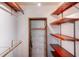 Custom walk-in closet with modern wood and metal shelving for optimal storage at 2990 Mallard Dr, Deltona, FL 32738