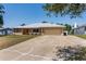 Home featuring a new silver metal roof and a large concrete driveway leading to a two car garage at 2990 Mallard Dr, Deltona, FL 32738