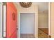A lovely home entryway features a bright red door, stylish overhead lighting and ceramic tile flooring at 2990 Mallard Dr, Deltona, FL 32738