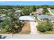 Aerial view of the home's exterior, complemented by a manicured lawn and mature trees at 2990 Mallard Dr, Deltona, FL 32738