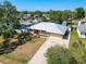 Aerial view of the home's exterior, enhanced by a well-manicured lawn and tree-lined streets at 2990 Mallard Dr, Deltona, FL 32738