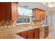 Charming kitchen featuring wood cabinets, mosaic backsplash, and a window view at 2990 Mallard Dr, Deltona, FL 32738