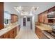 Bright, open kitchen with wooden cabinets, stainless steel appliances, and tile flooring at 2990 Mallard Dr, Deltona, FL 32738