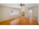 Bright living room featuring hardwood floors, a large window, and a ceiling fan for added comfort at 2990 Mallard Dr, Deltona, FL 32738