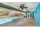 Covered screened-in pool and lounge area with ceiling fans offers the perfect outdoor retreat at 2990 Mallard Dr, Deltona, FL 32738