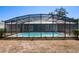 Exterior shot of the screened-in pool offering privacy and a relaxing atmosphere at 2990 Mallard Dr, Deltona, FL 32738