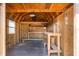 Inside the shed with exposed beams, window, and wooden workbench at 2990 Mallard Dr, Deltona, FL 32738