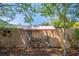 A neatly stacked woodpile is sheltered by a small roof in a shady corner of the yard at 2990 Mallard Dr, Deltona, FL 32738