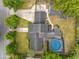 An aerial view of the home featuring a large swimming pool, spacious backyard, and a long driveway at 3019 Page Ave, Orlando, FL 32806