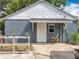Exterior view of the home's facade and backyard, showing the concrete patio at 3019 Page Ave, Orlando, FL 32806