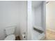 Bathroom showcasing a walk-in shower with white tiles, a toilet, and tile flooring at 3019 Page Ave, Orlando, FL 32806