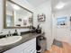 Bathroom showcasing granite vanity, ample storage, and large well lit mirror at 3019 Page Ave, Orlando, FL 32806