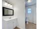 Bathroom with a white vanity, framed mirror, and tiled flooring at 3019 Page Ave, Orlando, FL 32806