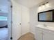 Bathroom featuring a single sink vanity and view to living room at 3019 Page Ave, Orlando, FL 32806
