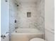 Bathroom with a tiled shower over tub and a shower head at 3019 Page Ave, Orlando, FL 32806