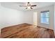 Well-lit bedroom features wood floors, white walls, ceiling fan, and a window for natural light at 3019 Page Ave, Orlando, FL 32806