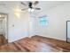 Bedroom featuring wood-look floors, closet and an updated window with an exterior view and interior lighting at 3019 Page Ave, Orlando, FL 32806