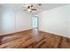 Well-lit bedroom features wood floors, white walls, ceiling fan, and a window for natural light at 3019 Page Ave, Orlando, FL 32806