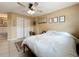 Neutral-toned bedroom featuring a fan, closet, and decor at 3019 Page Ave, Orlando, FL 32806