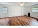 Spacious bedroom features wood floors, white walls, a ceiling fan, and windows for natural light at 3019 Page Ave, Orlando, FL 32806