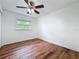 Cozy bedroom featuring wood-look floors and a ceiling fan at 3019 Page Ave, Orlando, FL 32806