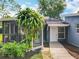 Home exterior with a screened in patio, lush landscaping and private entrance at 3019 Page Ave, Orlando, FL 32806