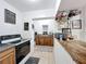 Kitchen with dark cabinets, modern appliances, and eat in breakfast bar at 3019 Page Ave, Orlando, FL 32806