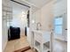 Bright laundry room featuring a sink, storage shelves, and tile flooring at 3019 Page Ave, Orlando, FL 32806