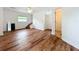 Open living room featuring wood-look floors, natural light, and access to the stairs at 3019 Page Ave, Orlando, FL 32806