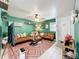This living room features green walls and warm accent furniture at 3019 Page Ave, Orlando, FL 32806