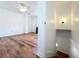Bright living room with wood-look floors and a ceiling fan, leading to a staircase at 3019 Page Ave, Orlando, FL 32806