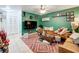 Comfortable living room features a large TV, patterned rug, and unique decor at 3019 Page Ave, Orlando, FL 32806